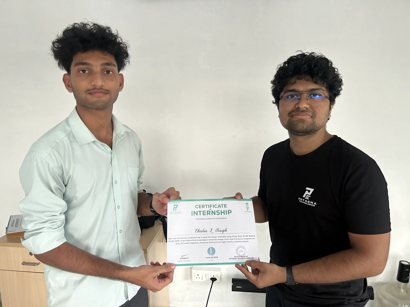 Student holding an internship certificate with the instructor